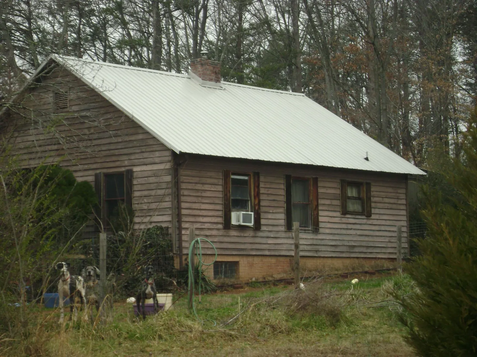 White metal roof on an old wood sided farmhouse, from a Metal Roof Installation job in College Corner